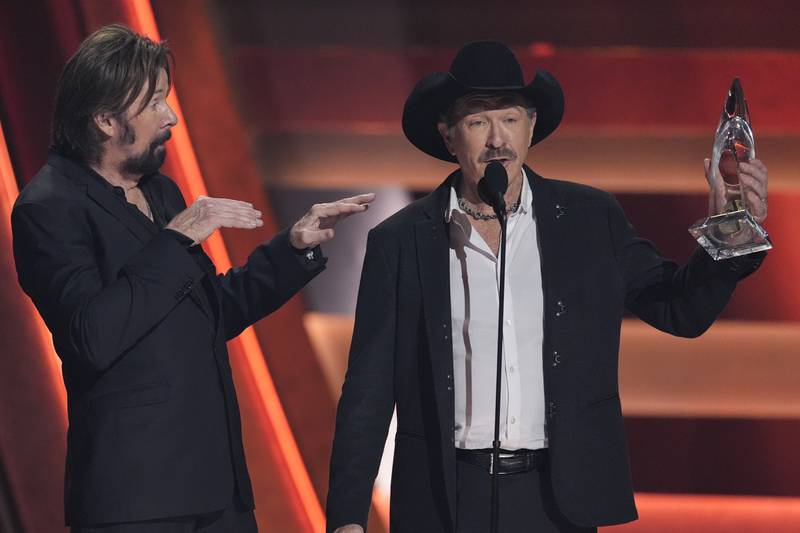 Ronnie Dunn, left, and Kix Brooks accept the award for vocal duo of the year during the 58th Annual CMA Awards on Wednesday, Nov. 20, 2024, at Bridgestone Arena in Nashville, Tenn. (AP Photo/George Walker IV)