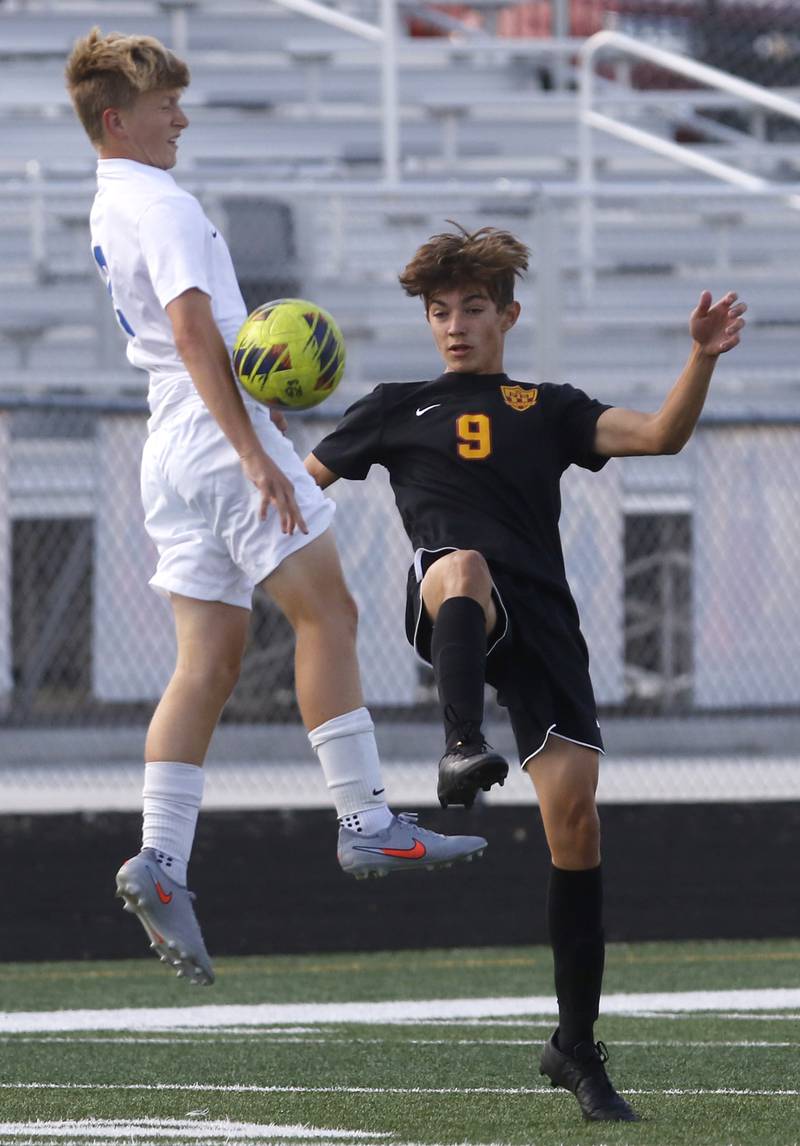 Woodstock’s Merrick Freund and Richmond-Burton’s Travis Roberts battle for the ball during a Kishwaukee River Conference soccer match on Wednesday, Sept. 10, 2025, at Richmond-Burton High School, in Richmond.
