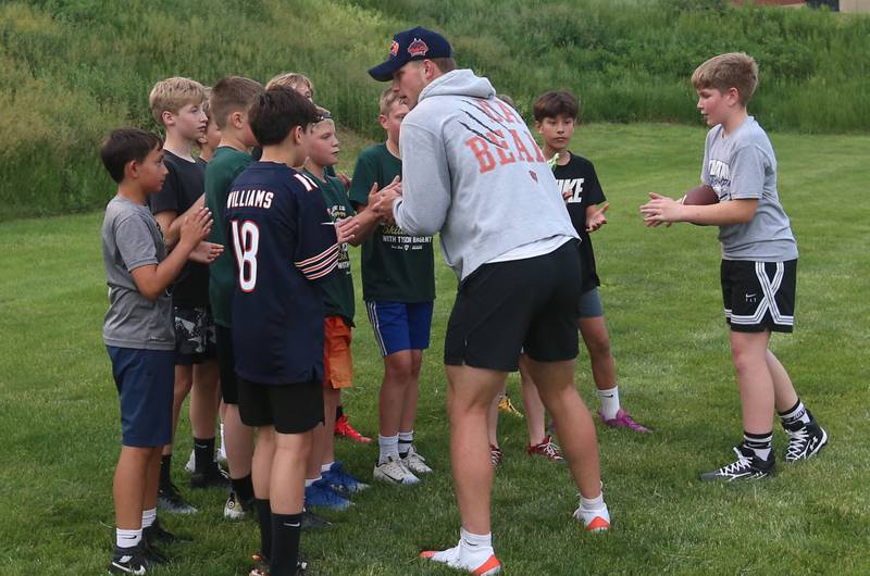 Chicago Bears quarterback Tyson Bagent huddles with a group of kids during the Tyson Bagent Offensive Skills Camp on Saturday, May 23, 2026 at St Bede Academy.