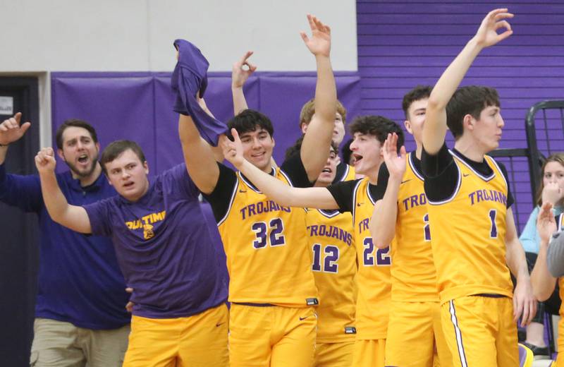 Members of the Mendota boys basketball team react as teammate Aden Tillman gets his 1,000th career point on Tuesday, Feb. 3, 2026 at Mendota High School.