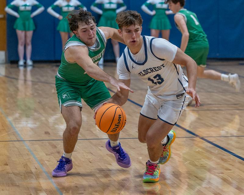 Layten Gerdes (13) of Fieldcrest dribbles ball as Drew Overocker (31) of Dwight reaches to steal ball on Monday, December 15, 2025 at Fieldcrest High School in Minonk.