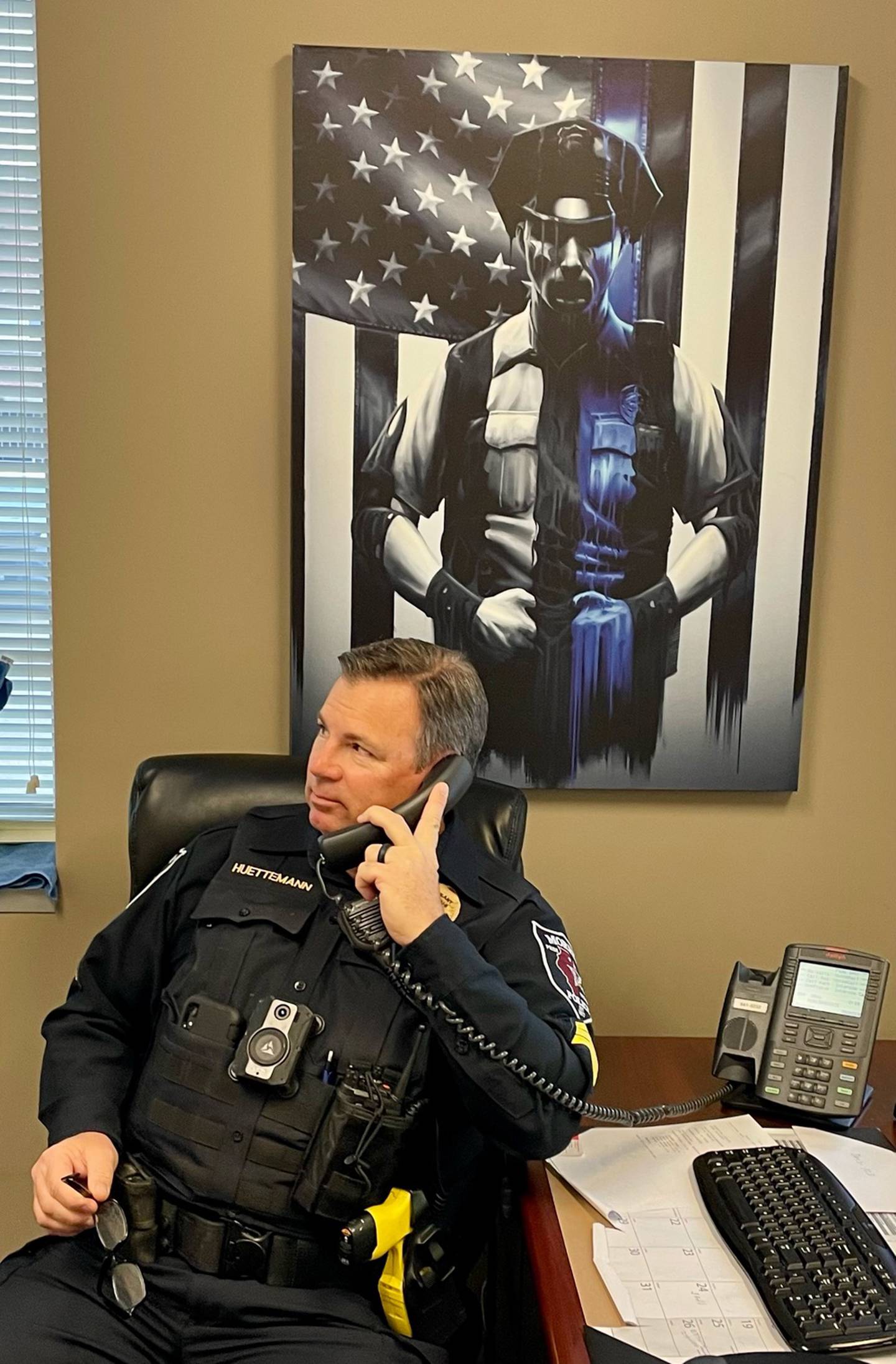 Sergeant Steve Huettemann takes a phone call in his office.