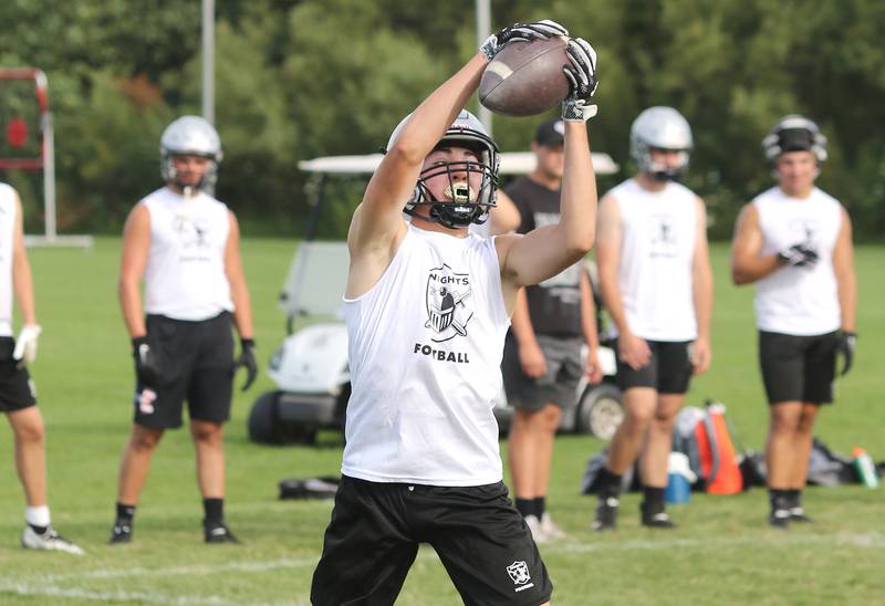A Kaneland player makes a catch during 7-on-7 drills against DeKalb Tuesday, July 26, 2022, at Kaneland High School in Maple Park.