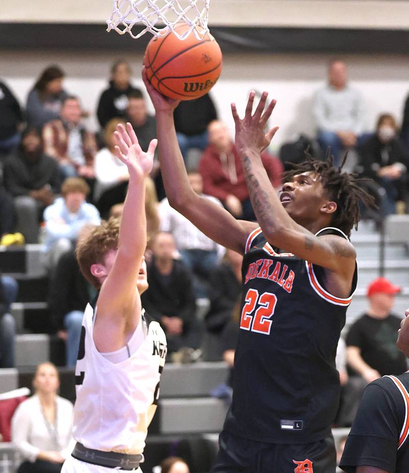 DeKalb's Darrell Island goes to the basket against Kaneland's Johnny Spallasso during their game Tuesday, Jan. 24, 2023, at Kaneland High School.