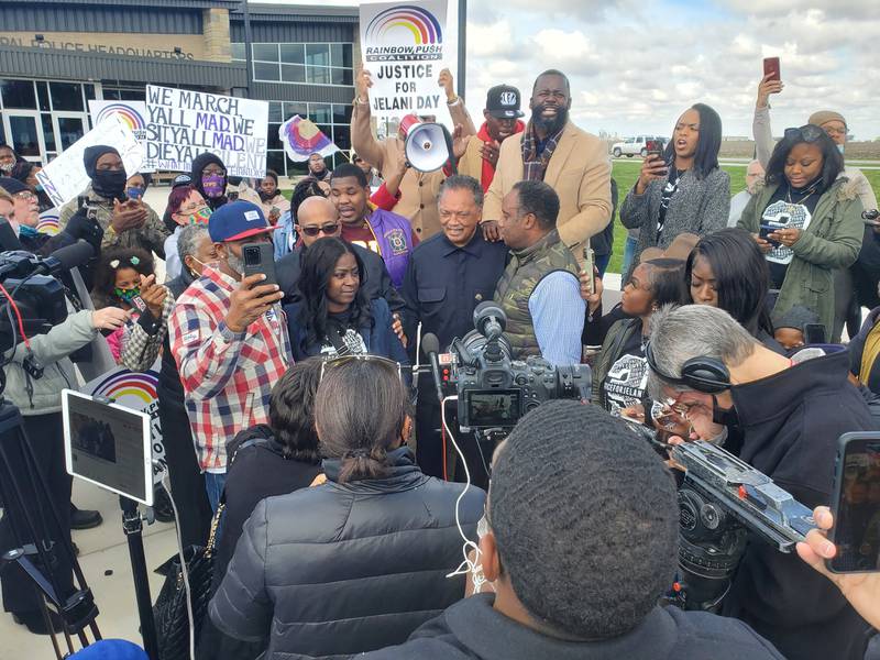 Jelani Day's mother Carmen Bolden Day, along with the Rev. Jesse Jackson and his son Jonathan speak in front of the Peru Police Department on Tuesday, Oct. 26, 2021, ahead of a march seeking more answers to the cause of Day's death.