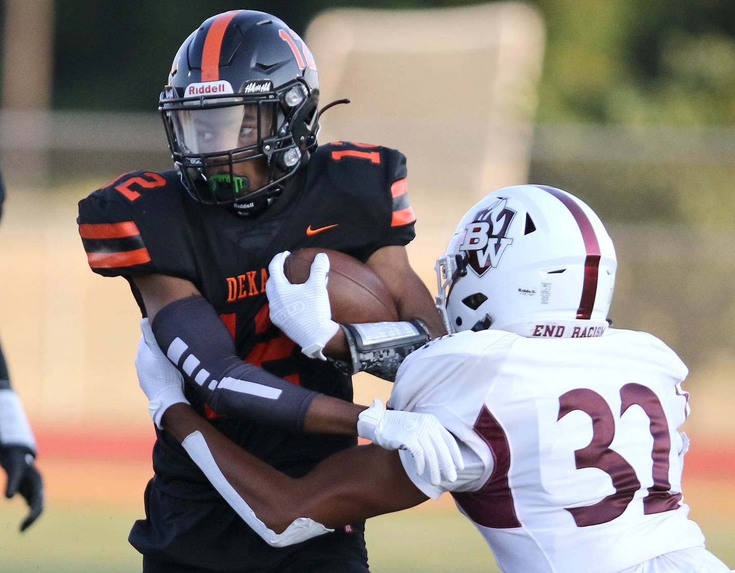 DeKalb wide receiver Ethan McCarter tries to break the tackle of Belleville West's Cameron Thurston during their game Friday, Sep. 10, 2021 at DeKalb High School.