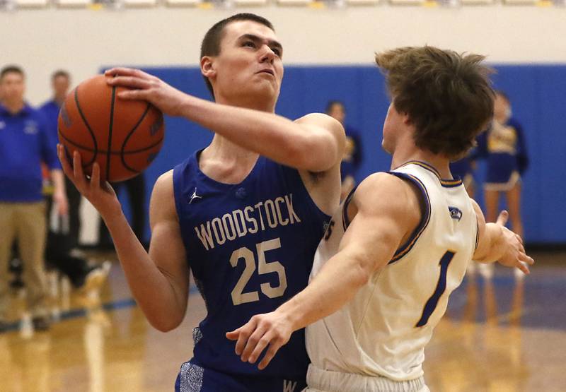 Woodstock’s Trent Butler drives to the basket against Johnsburg's Jake Metze during a Kishwaukee River Conference boys basketball game Tuesday, Jan. 31, 2023, at Johnsburg High School.