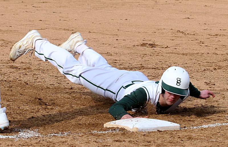 St. Bede's Brendan Pillion slides safely back into the bag at first base against Riverdale on Monday, March 20, 2023 at St. Bede Academy.