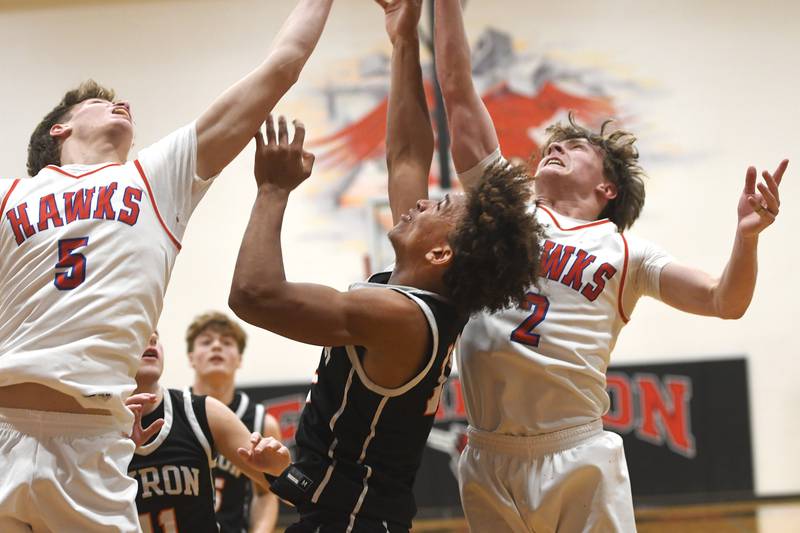 Oregon's Tucker O'Brien (left) and Cooper Johnson (right) battle Byron's JJ Edmonson (center) for a rebound on Monday, Dec. 15, 2025 at the 64th Forreston Holiday Tournament at Forreston High School.