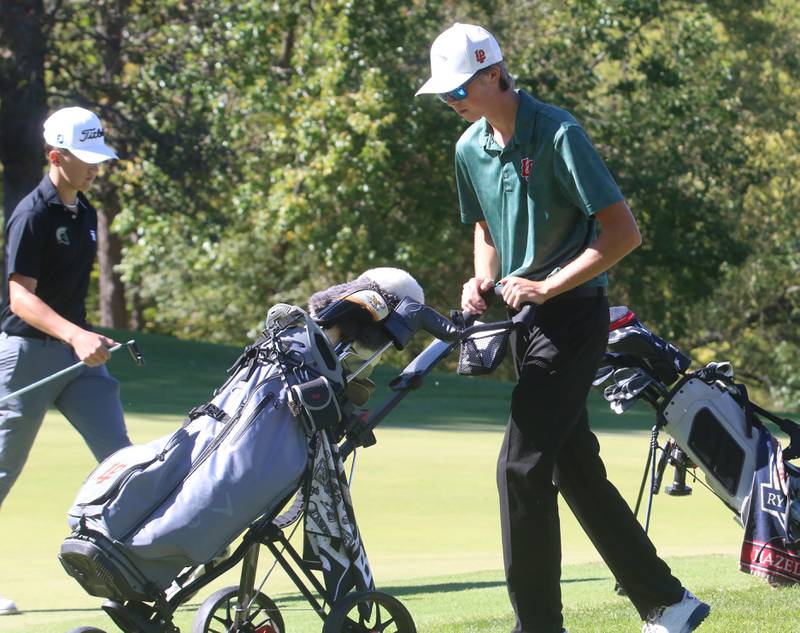L-P's Michael Milota pushes his cart after making a put while Sycamore's Andrew Swedberg walks back to his clubs during the Class 2A Regional golf meet on Wednesday, Oct. 2, 2024 at Senicas Oak Ridge Golf Club in La Salle.