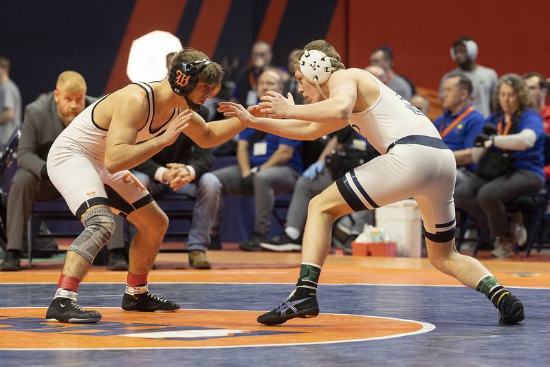 IC Catholic’s Aiden Arnett (left) and Washington’s Peyton Cox compete in the 144 pound weight class of the 2A state individual wrestling finals Saturday, Feb. 22, 2025, at State Farm Center in Champaign.