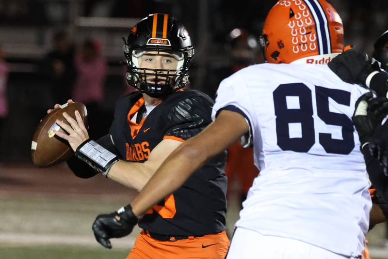 DeKalb's Michael Hodge throws a pass ahead of the pressure of Stagg’s Saajan Ayers during their game Friday, Oct. 25, 2024, at DeKalb High School.