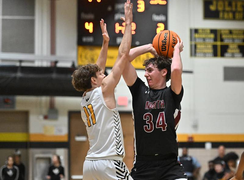 Plainfield North's Quintin Wiencek (34) looks to pass the ball during a conference game against Joliet West on Friday, Dec. 20, 2024, at Joliet.