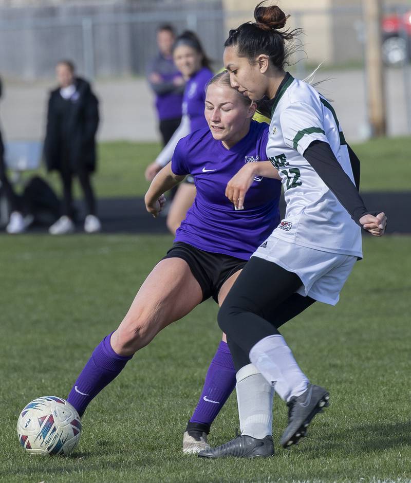 Dixon’s Micki Worrell works against North Boone’s Julia Garbacz for the ball Tuesday, April 15, 2025.