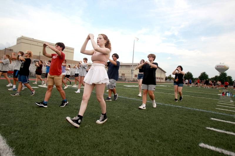 Members of the Batavia High School marching band walk through their choreography during band camp at the school on Tuesday, July 30, 2024.