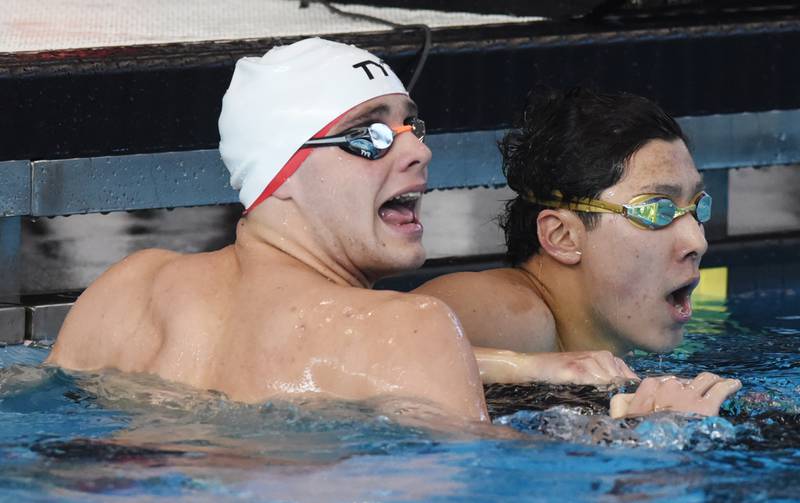 Hinsdale Central’s Joshua Bey, left, winner of the 200-yard individual medley, views his time alongside teammate Jeffrey Hou, who finished second, during the boys state swimming and diving finals at FMC Natatorium on Saturday, Feb. 24, 2024 in Westmont.