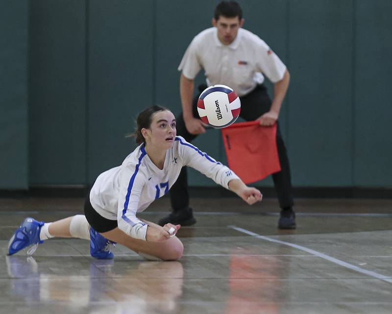St Charles North's Addison Kashuba (17) dives for dig save during Class 4A Glenbard West Sectional final volleyball match between St Charles North at Benet. Nov 6, 2025 in Glen Ellyn.
