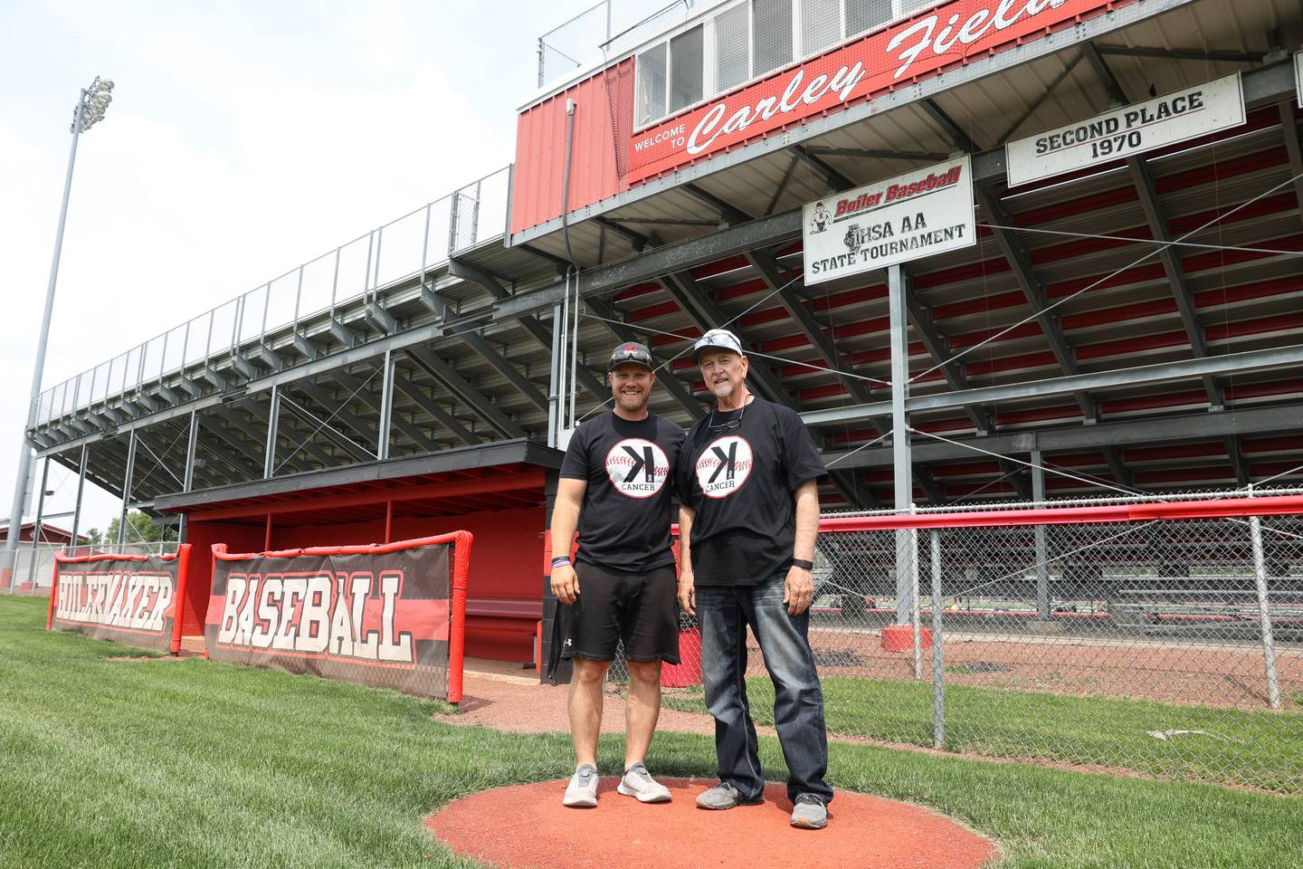 Bradley-Bourbonnais baseball coach Brad Schweigert, left, stands with his father, Keith Schweigert on the field.