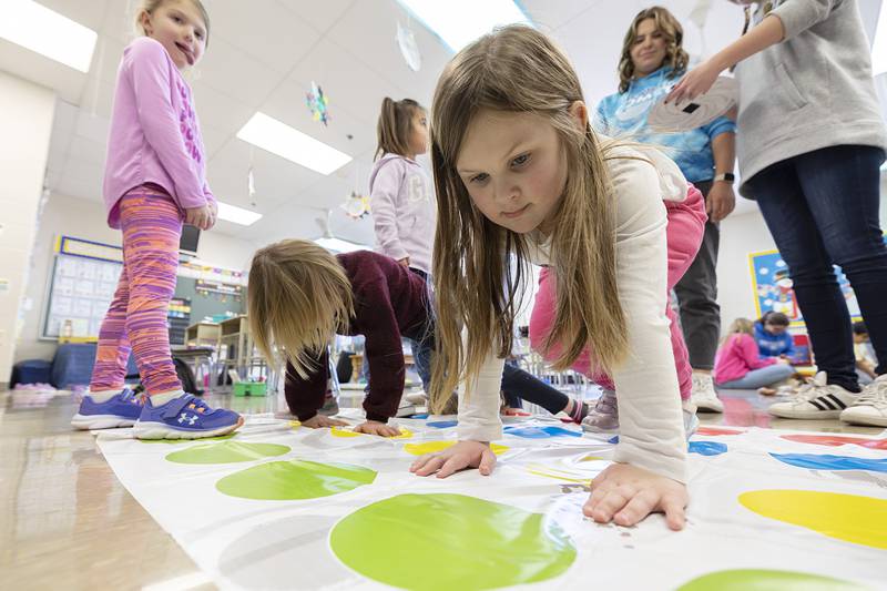 St. Mary’s School kindergartener Annabelle Bramm looks for her spot on the Twister mat Thursday, Feb. 2, 2023 during a day of fun in recognition of Catholic Schools Week.