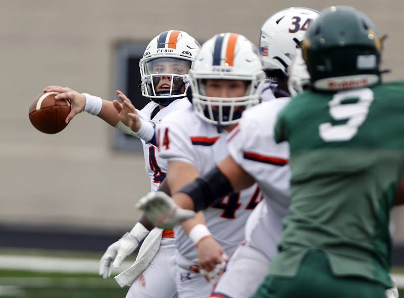 Oswego's Drew Kleinhans (4) gets ready to pass during the varsity football second-round 8A playoff game between Oswego and Lane Tech on Saturday, Nov. 8, 2025 in Chicago.
