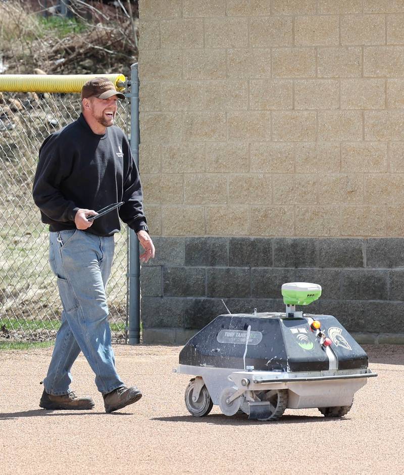 Nik Vinz, maintenance for Sycamore Community School District 427, uses a robot to line the softball field Tuesday, April 11, 2023, for that nights game at Sycamore High School.