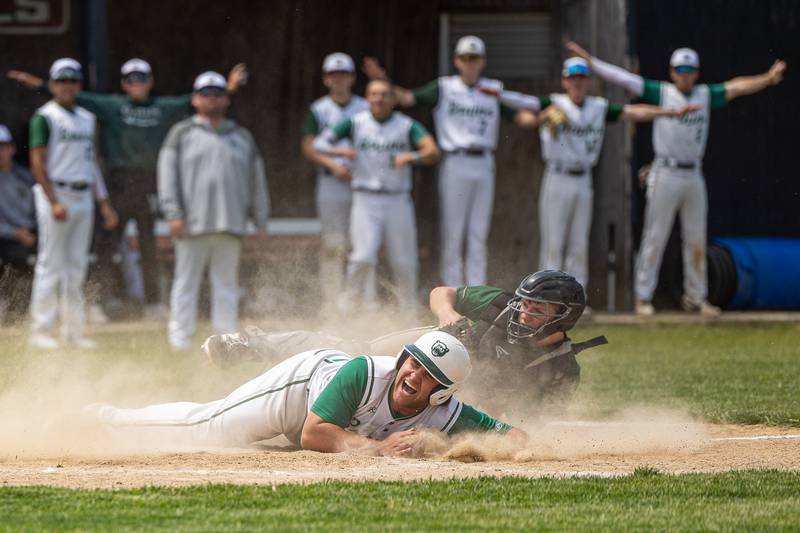 (22) Alan Spencer of St. Bede screams after being tagged at home plate by (30) Z. Schwanke of Midland as teammates motion for safe call in close game of Class 1A Regional Final game on Saturday, May 24, 2025 at Stark County High School in Toulon.