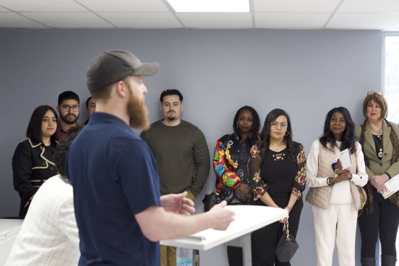 Skyler Reed (left), Joliet Township food pantry coordinator, delivers a speech on Monday, April 21, 2025, as part of a ribbon-cutting ceremony for the food pantry at the township's Forest Park Community Center in Joliet.