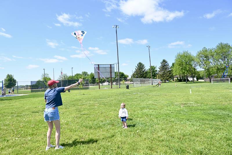 Sophie Hiller, of Ottawa, watches her mom fly her Minnie Mouse kite on Sunday May 18, 2025 during Kites in Flight at Peck Park in Ottawa.