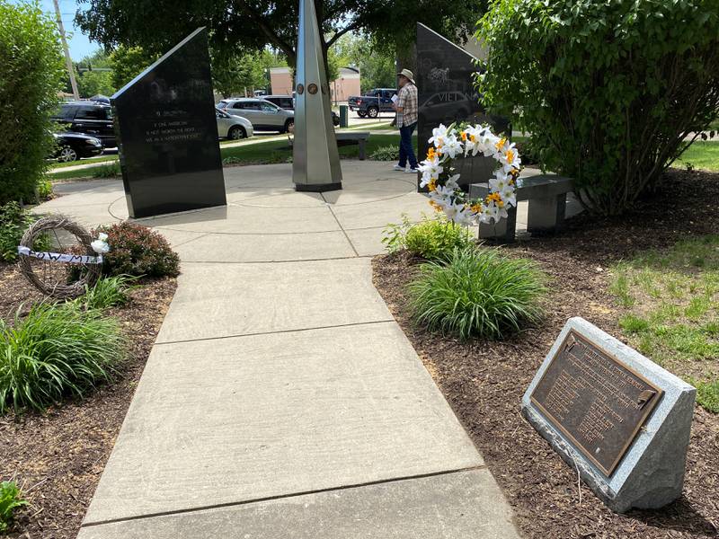 Wreaths honoring those lost lay with the war memorial on the lawn at the Grundy County Courthouse.