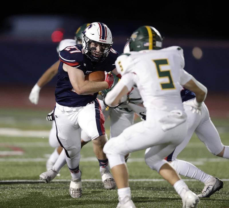 Conant's Dominic Mininni, (27) tries to moves past Glenbrook North's Jack Philbin (5) Friday September 9, 2022 in Schaumburg.