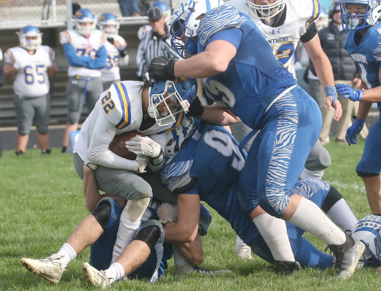 Paxton-Buckley-Loda's Kayden Vance is brought down behind the line of scrimmage by Princeton's Common Green, Arthur Burden and Payne Miller in the Class 3A playoff game on Saturday, Oct. 28, 2023 at Bryant Field.