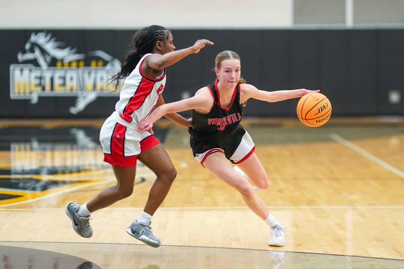 Yorkville's Macie Jones (4) brings the ball up the court against Bolingbrook's Airyel Jackson (1) during a Class 4A Metea Valley Regional final basketball game at Metea Valley High School in Aurora on Friday, Feb. 21, 2025.