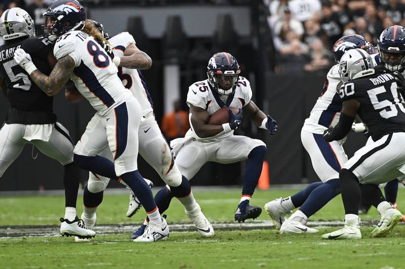 Denver Broncos running back Melvin Gordon III (25) runs the ball against the Las Vegas Raiders during the first half of an NFL football game in Las Vegas. (AP Photo/David Becker)