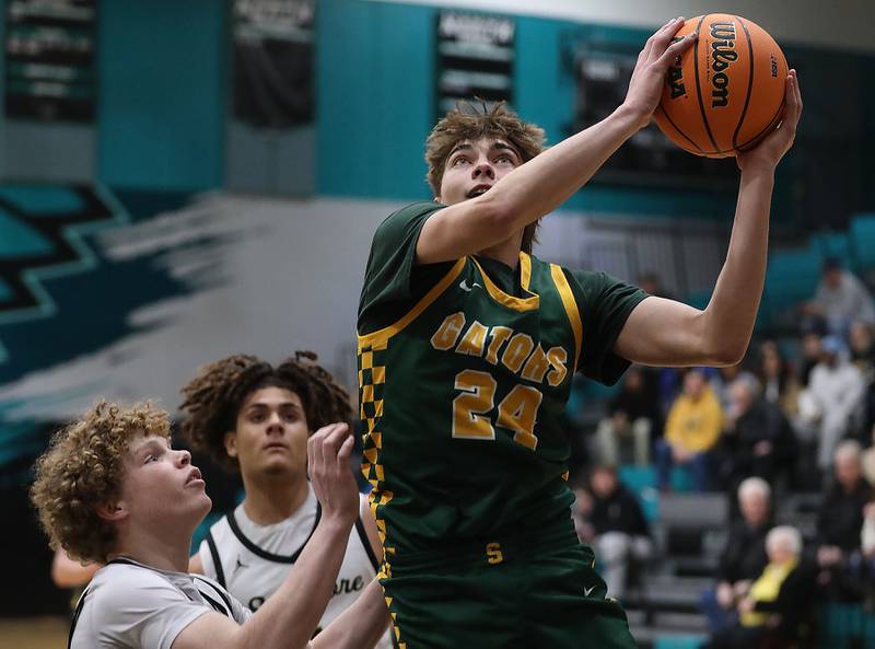 Crystal Lake South's Vincent Santarelli drives to the basket against Sycamore's Logan Hodges during an IHSA Class 3A Woodstock North Sectional semifinal.basketball game on Wednesday, March 4, 2025, at Woodstock North High School.