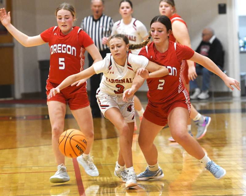 Forreston's Tenlei Patterson (3) battles Oregon's Avery Kitzmiller (2) and Shaylee Davis (5) for a loose ball on Saturday, Jan. 3, 2026 at Forreston High School.
