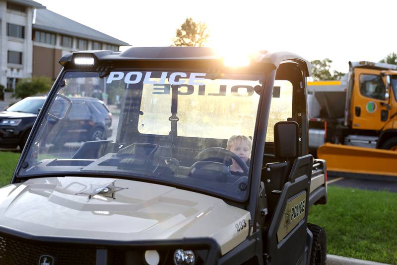 Henry Zimmerman, 3, of Lake in the Hills sits in the driver’s seat of a Kane County Forest Preserve vehicle during the Kane County Sheriff’s Office National Night Out event in St. Charles on Tuesday, Aug. 1, 2023. The community-building event began nationally in 1984.