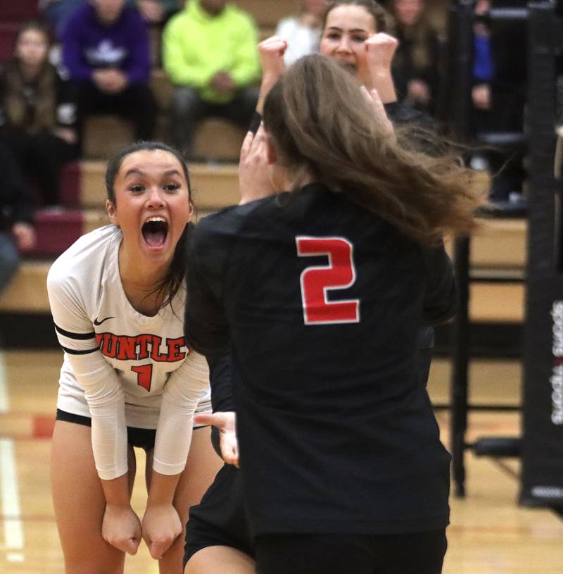 Huntley’s Sophia Tocmo and the Red Raiders celebrate a point against  Hampshire in girls varsity volleyball at Huntley High School on Thursday, October 23, 2025.