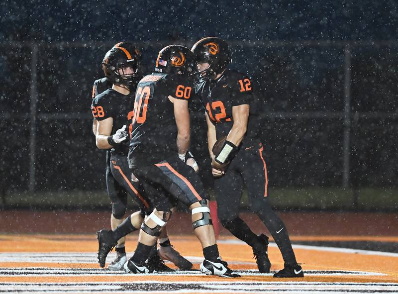 Lincoln-Way West's Grant Tustin (12) celebrates with Brayden Niemeyer after scoring a touchdown during the conference game against Lincoln-Way Central 3on Friday, SEP. 19, 2025, at New Lenox.