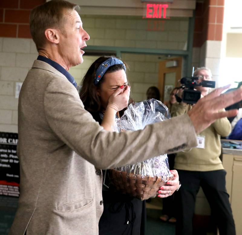 Bolingbrook High School teacher Erin Clifford, with Golden Apple Foundation President Alan Mather, was surprised by her family, colleagues, students and Golden Apple Foundation officials on Tuesday, May 6, 2025 as it was announced she had won a Golden Apple Award for Excellence in Teaching.