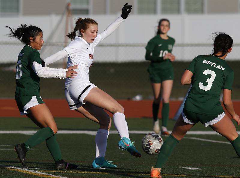 Huntley's Maddie Rumachik tries to control the ball in between Boylan Catholic's Johanna Hawley (left) and Ava Galluzzo (right) during a nonconference soccer game on Wednesday, March 27, 2024, at Huntley High School.