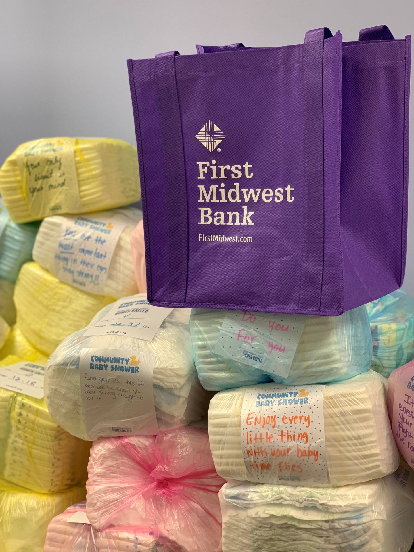 These diaper bundles were from a volunteer event in partnership with First Midwest Bank. Bank employees took 4,250 diapers and prepared them into 170 community baby shower bundles.