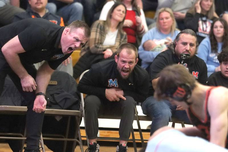 Marian’ Central's Head Coaches Jordan Blanton, left, and Ryan Prater encourage the Hurricanes during a win over Washington in varsity boys wrestling on Thursday, Feb. 5, 2026, at Sycamore High School in Sycamore.