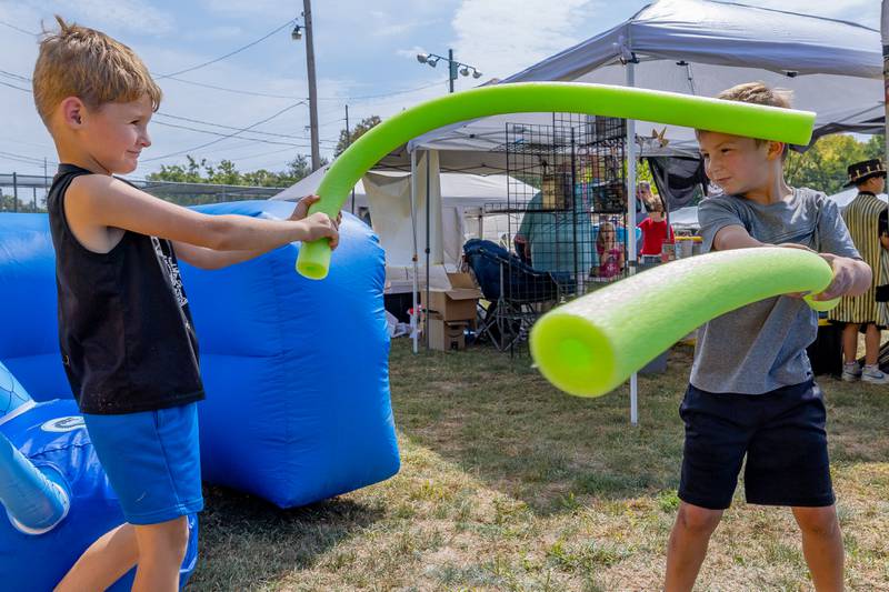 Bentley Benjamin, 5, (left) battles Jaxon Kent, 6, (right) with foam swords at the Marseilles Renaissance Faire on September 13, 2025 in Marseilles.