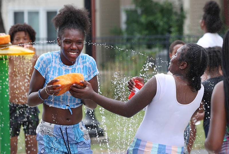 Kids play on the splash pad Thursday, June 20, 2024, at the DeKalb Park District’s Welsh Park. High temperatures have been over 90 degrees every day this week making splash pads and pools very popular destinations.