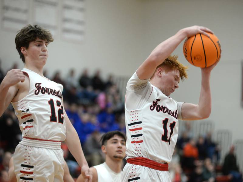 Forreston's Connor Politsch (11) rebounds as Darin Greenfield (11) watches against Eastland draws on Saturday, Jan. 4, 2025 at Forreston High School.