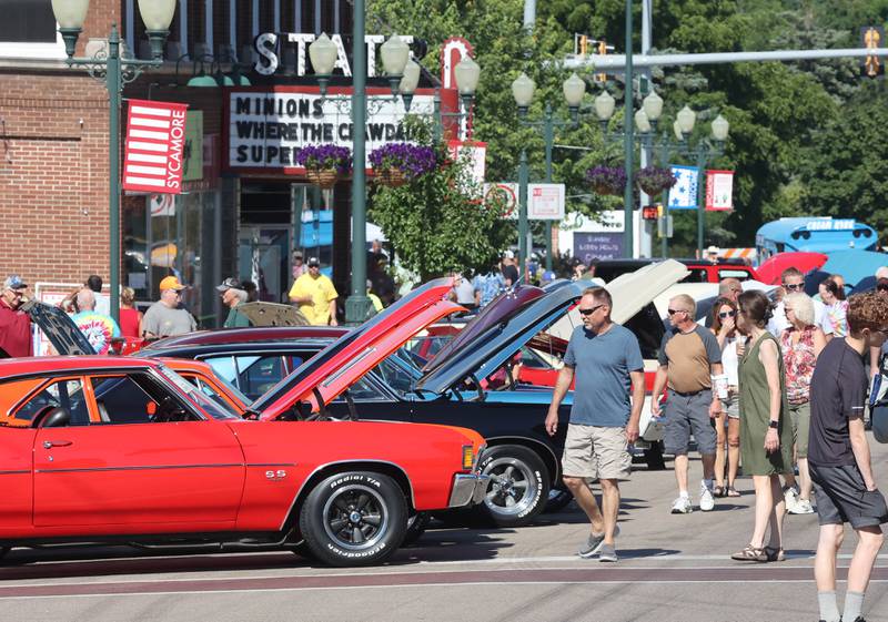 Visitors check out the cars on State Street in Sycamore Sunday, July 31, 2022, during the 22nd Annual Fizz Ehrler Memorial Car Show.