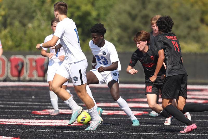 Lincoln-Way East’s Dennis Apraku works the ball through traffic against Bolingbrook on Saturday, Sept. 30, 2023 in Bolingbrook.