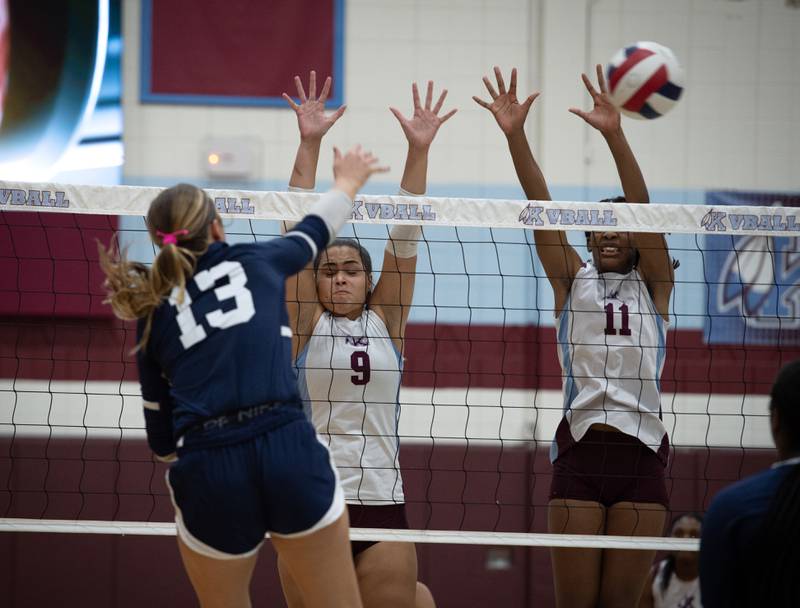 Kankakee's Karmen Rodgers, center, and Shania Johnson, right, defend a hit from Grace Christian's Gracie Reynolds during a match on Monday, September 22, 2025.