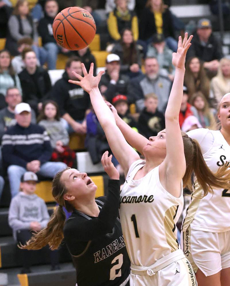 Kaneland's Kailey Plank and Sycamore's Mallory Armstrong go after a rebound during the Class 3A regional final game Friday, Feb. 17, 2023, at Sycamore High School.