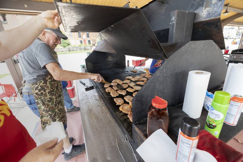 Randy Larson flips a chop Monday, July 22, 2024 while preparing the lunches for the Rotary clubs' Broil and Boil.